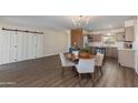 Open-concept living and dining area with modern lighting, neutral decor, and stylish wood-look flooring throughout at 4325 W Sierra St, Glendale, AZ 85304