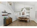 Bright dining area featuring a staircase, vaulted ceilings, stylish decor, and seamless flow into adjacent spaces at 4554 E Coyote Wash Dr, Cave Creek, AZ 85331