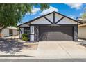 Home featuring a two-car garage with exterior stone details and manicured landscaping at 4808 E Betty Elyse Ln, Scottsdale, AZ 85254