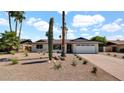 Attractive single-story home with desert landscaping, a two-car garage, and a well-maintained front yard at 5109 E Blanche Dr, Scottsdale, AZ 85254