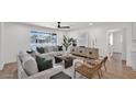 Stylish living room with comfortable seating, a large window, neutral decor, and wood-look flooring at 5109 E Blanche Dr, Scottsdale, AZ 85254