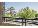 Balcony view showcasing mature trees, street views, and partial views of a distant mountain at 5345 E Van Buren St # 305, Phoenix, AZ 85008