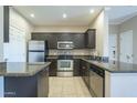 Kitchen showcasing stainless steel appliances, granite countertops, and a breakfast bar area at 5345 E Van Buren St # 305, Phoenix, AZ 85008
