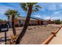 A charming single Gathering home with low maintenance desert rock landscaping and an attached two car garage at 5721 W Palo Verde Ave, Glendale, AZ 85302