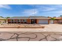 Beautiful single-story brick home with low maintenance desert rock landscaping and a two car garage at 5721 W Palo Verde Ave, Glendale, AZ 85302
