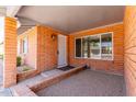 Welcoming front porch with brick facade, window and covered entryway at 5721 W Palo Verde Ave, Glendale, AZ 85302