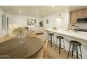 Open concept kitchen and living room features modern lighting, neutral tones, and stylish decor at 628 N Hobson --, Mesa, AZ 85203