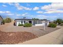 Charming one-story home with an easy-to-maintain gravel yard, complemented by vibrant flowering bushes at 635 N 67Th Pl, Mesa, AZ 85205