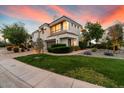 Modern two-story home featuring a manicured lawn, mature trees, and a well-maintained landscape at 7222 E Gainey Ranch Rd # 241, Scottsdale, AZ 85258