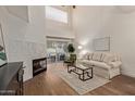 Bright living room features high ceilings, fireplace, modern furniture, and sliding glass doors at 7710 E Gainey Ranch Rd # 142, Scottsdale, AZ 85258