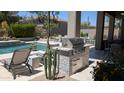 Outdoor kitchen area with a built-in stainless steel grill, perfect for outdoor cooking and entertaining at 7940 E Quill Ln, Scottsdale, AZ 85255