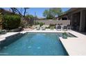 Stunning pool with clear blue water and lounge chairs, perfect for relaxation and outdoor enjoyment at 7940 E Quill Ln, Scottsdale, AZ 85255