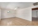 Bright living room featuring tile flooring, neutral paint, and a ceiling fan for added comfort at 8101 E 4Th Ave, Mesa, AZ 85208