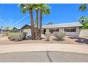 Inviting home features a well-manicured front yard and charming curb appeal at 8326 E Valley View Rd, Scottsdale, AZ 85250