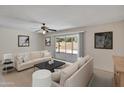 Bright living room with sliding glass doors leading to patio and backyard at 8326 E Valley View Rd, Scottsdale, AZ 85250