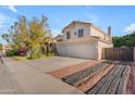 Attractive two-story home showcasing a well-maintained yard, mature landscaping, a large driveway and a 2-car garage at 8931 W Alex Ave, Peoria, AZ 85382