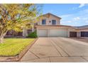 Charming two-story home featuring a spacious driveway, lush green lawn, mature landscaping, and a 2-car garage at 8931 W Alex Ave, Peoria, AZ 85382