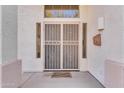 Inviting front door with ornate security gate, a decorative welcome mat, and charming welcome sign at 8931 W Alex Ave, Peoria, AZ 85382