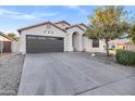 Inviting single-story home featuring a wide driveway and a welcoming front entrance with desert landscaping at 896 N Kingston St, Gilbert, AZ 85233