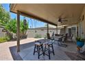 Spacious covered patio with a ceiling fan, outdoor furniture, and views of the backyard at 10648 W Loma Blanca Dr, Sun City, AZ 85351