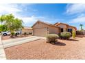 Inviting single-story home with a well-maintained front yard and a convenient two-car garage at 13022 W Cherry Hills Dr, El Mirage, AZ 85335