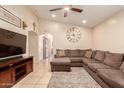 Cozy living room with neutral colors, a ceiling fan, and comfortable seating area at 13022 W Cherry Hills Dr, El Mirage, AZ 85335