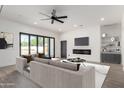 Stylish living room features a modern fireplace, a ceiling fan, and glass patio doors at 1304 W Ocotillo Rd, Phoenix, AZ 85013