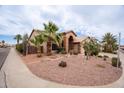 Lovely single-story home with desert landscaping featuring native plants, palm trees and a two-car garage at 15809 S 31St St, Phoenix, AZ 85048