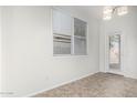 Bright dining room features tile flooring and a glass door leading to the outside at 15941 N 171St Ln, Surprise, AZ 85388
