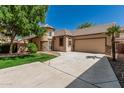 Charming single-story home features stucco siding, a tiled roof, and a spacious driveway leading to an attached garage at 15941 N 171St Ln, Surprise, AZ 85388