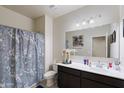 Functional bathroom with a shower, a dark vanity, and a wide mirror at 18711 W Farmer Rd Rd, Buckeye, AZ 85326