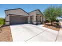Lovely single-story home with a spacious driveway, desert landscaping, and modern architectural design at 18711 W Farmer Rd Rd, Buckeye, AZ 85326
