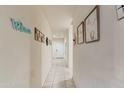 Bright hallway featuring neutral walls, tiled floors, and tasteful decor, creating an inviting atmosphere at 18711 W Farmer Rd Rd, Buckeye, AZ 85326