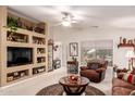 Inviting living room featuring neutral colors, built-in shelving, and a comfortable seating area at 19822 N 108Th Ave, Peoria, AZ 85373