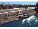 Scenic view of the community with a waterfall feature leading into the lake and well-kept homes at 20211 N Winter Escape Ct, Maricopa, AZ 85138