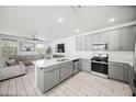 Bright, open kitchen with a large island, sleek gray cabinetry, and stainless steel appliances at 20872 W Thomas Rd, Buckeye, AZ 85396