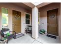 Cozy covered front porch features seating and potted plants at 22323 E Via Del Jardin --, Queen Creek, AZ 85142