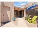 Inviting gated front courtyard with seating area, umbrella and desert landscaping at 2313 S Grandview Ave, Tempe, AZ 85282