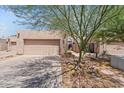 Home exterior with two-car garage, desert landscaping, and gated courtyard at 2313 S Grandview Ave, Tempe, AZ 85282