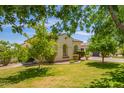Well-maintained front yard with lush greenery, mature trees and decorative bushes at 2457 E Melrose St, Mesa, AZ 85213