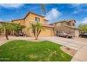 Tan two-story home with desert landscaping and a covered car in the driveway at 25806 W Hilton Ave, Buckeye, AZ 85326