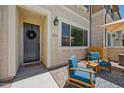 Inviting front entrance with a wreath on the gray door and cozy patio seating under a shade umbrella at 2628 S Voyager Dr # 104, Gilbert, AZ 85295