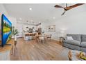 Open-concept living room featuring hardwood floors, modern furnishings, and a view into the stylish kitchen at 2628 S Voyager Dr # 104, Gilbert, AZ 85295