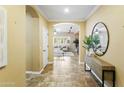 Inviting entryway featuring neutral paint, arched doorway, tile floors, and views into the living space at 2736 E Sourwood Dr, Gilbert, AZ 85298