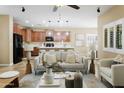 Open concept living room with a view into the kitchen, neutral decor, and a comfortable seating area at 2736 E Sourwood Dr, Gilbert, AZ 85298
