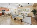 Bright living room with tile floors, neutral furniture, ceiling fan, and lots of natural light at 2736 E Sourwood Dr, Gilbert, AZ 85298