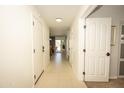 Bright hallway featuring neutral tile, white doors, and recessed lighting at 29110 N 24Th Ln, Phoenix, AZ 85085