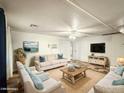 Bright living room showcasing neutral decor, comfortable seating, and media setup for cozy relaxation and entertainment at 2929 E Main St # 471, Mesa, AZ 85213