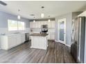 Bright kitchen boasts white cabinets, stainless steel appliances, and an island, perfect for cooking and entertaining at 3026 E San Manuel Rd, San Tan Valley, AZ 85143