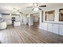 Open-concept living space with hardwood floors connecting the living area and kitchen, filled with natural light at 3026 E San Manuel Rd, San Tan Valley, AZ 85143